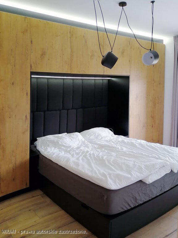 Projektant wnętrz Wrocław przedstawia na foto sypialnia z łóżkiem