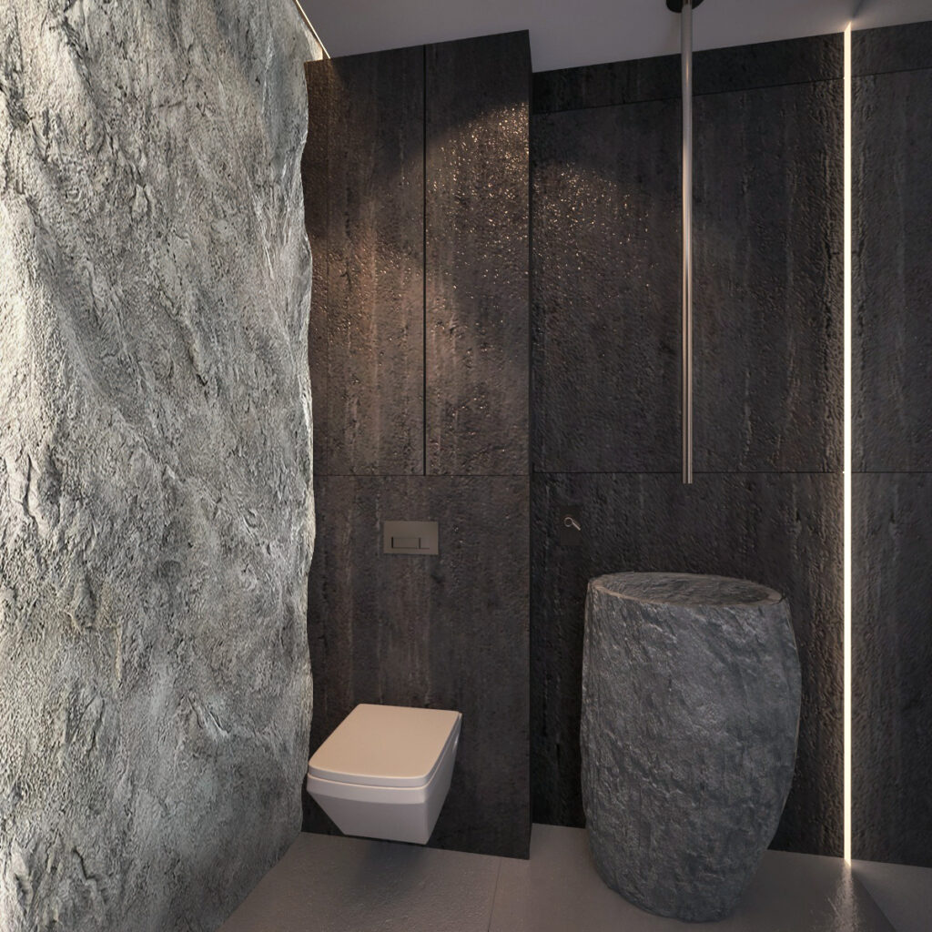 Projektant wnętrz Wrocław pokazuje łazienkę z sedesem i ścianą kamienną jak grota